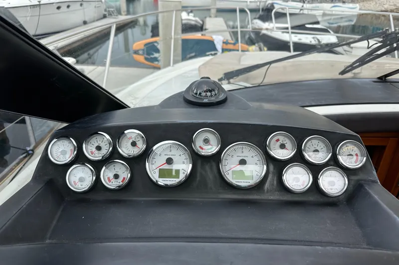  Yacht Photos Pics Dashboard of a 2015 Jeanneau NC11 boat with multiple gauges and compass.