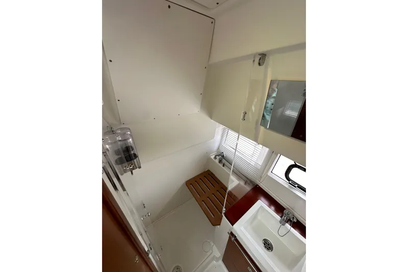  Yacht Photos Pics Bathroom interior of 2015 Jeanneau NC11 yacht with sink and shower area.