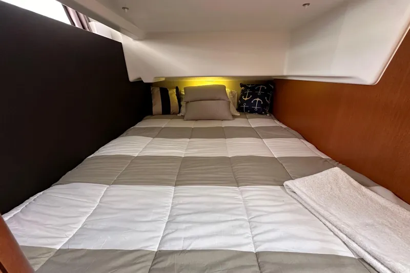  Yacht Photos Pics Cozy cabin bed in 2015 Jeanneau NC11 yacht with nautical-themed pillows.