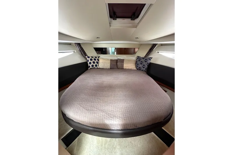  Yacht Photos Pics Luxurious cabin interior of 2015 Jeanneau NC11 yacht with cozy bedding and stylish decor.