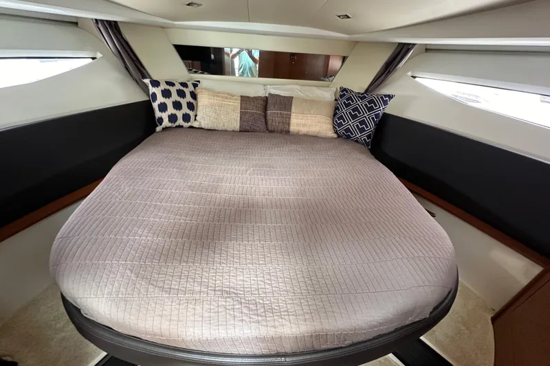  Yacht Photos Pics Cozy cabin interior of 2015 Jeanneau NC11 with stylish bedding and pillows.