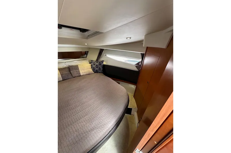  Yacht Photos Pics 2015 Jeanneau NC11 cabin interior with cozy bed and modern design.