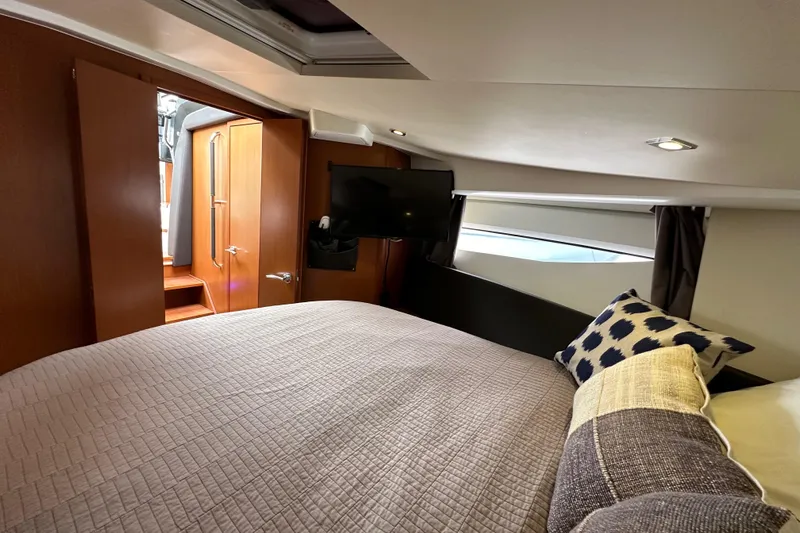  Yacht Photos Pics Cozy bedroom interior of 2015 Jeanneau NC11 yacht with modern decor and natural light.