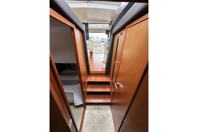  Yacht Photos Pics Interior view of 2015 Jeanneau NC11 yacht, featuring wooden stairs and modern design.