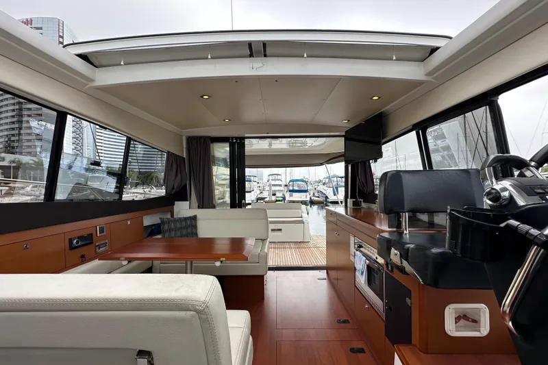  Yacht Photos Pics Interior of 2015 Jeanneau NC11 yacht with modern design and spacious seating area.
