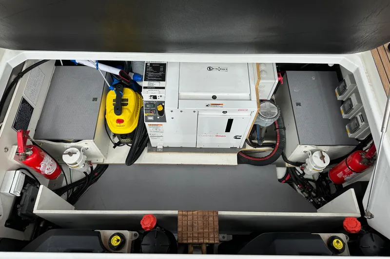  Yacht Photos Pics Engine compartment of 2015 Jeanneau NC11 boat with generator and safety equipment.