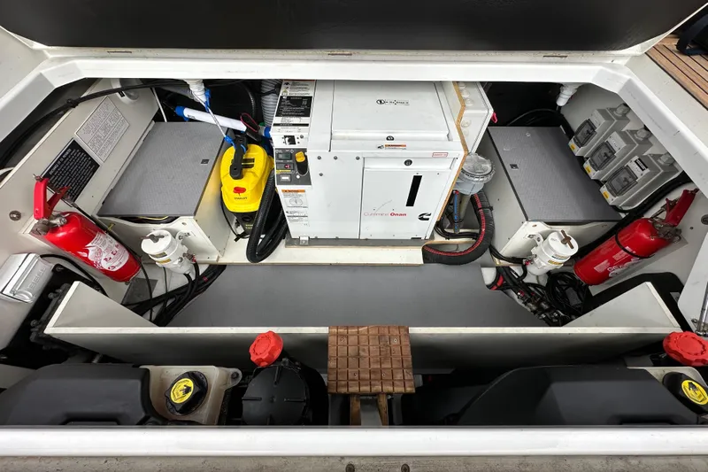  Yacht Photos Pics Engine compartment of 2015 Jeanneau NC11 boat with Cummins Onan generator and safety equipment.