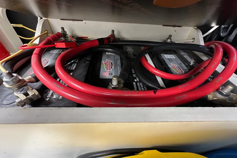  Yacht Photos Pics Battery compartment of a 2015 Jeanneau NC11 with red and black cables.