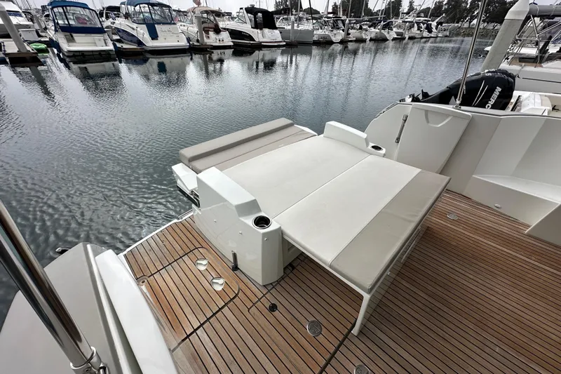  Yacht Photos Pics 2015 Jeanneau NC11 boat with teak deck and seating area in marina.