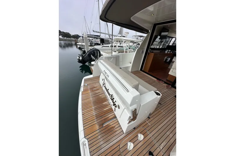 Yacht Photos Pics 2015 Jeanneau NC11 yacht with teak deck, docked at marina.