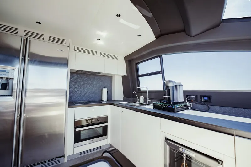 Transcendence Yacht Photos Pics Modern kitchen interior on 2020 Azimut 78 Flybridge yacht, featuring stainless steel appliances and sleek design.