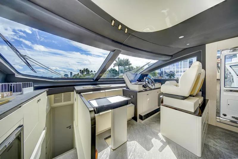 Transcendence Yacht Photos Pics Luxurious interior of 2020 Azimut 78 Flybridge yacht with modern helm and panoramic windows.