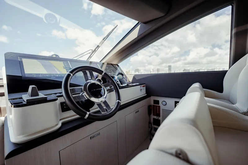 Transcendence Yacht Photos Pics Luxurious helm of 2020 Azimut 78 Flybridge yacht with modern controls and panoramic view.