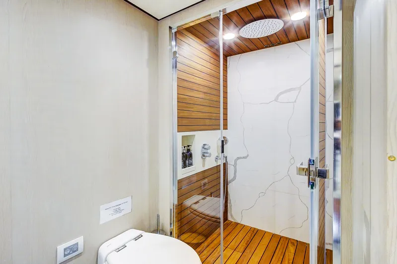 Transcendence Yacht Photos Pics Luxurious bathroom in 2020 Azimut 78 Flybridge yacht with modern shower and wooden accents.
