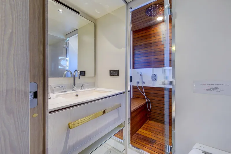 Transcendence Yacht Photos Pics Luxurious bathroom on 2020 Azimut 78 Flybridge yacht with modern fixtures and wooden accents.
