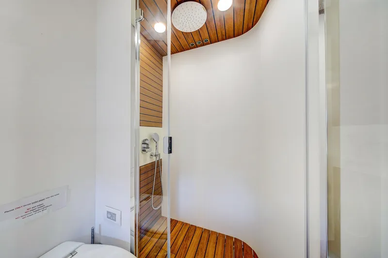 Transcendence Yacht Photos Pics Luxurious shower area in 2020 Azimut 78 Flybridge yacht with wood accents.