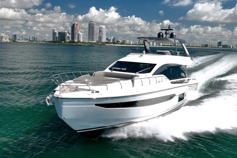 Transcendence Yacht Photos Pics Azimut 78 Flybridge 2020 yacht cruising near city skyline under blue sky.
