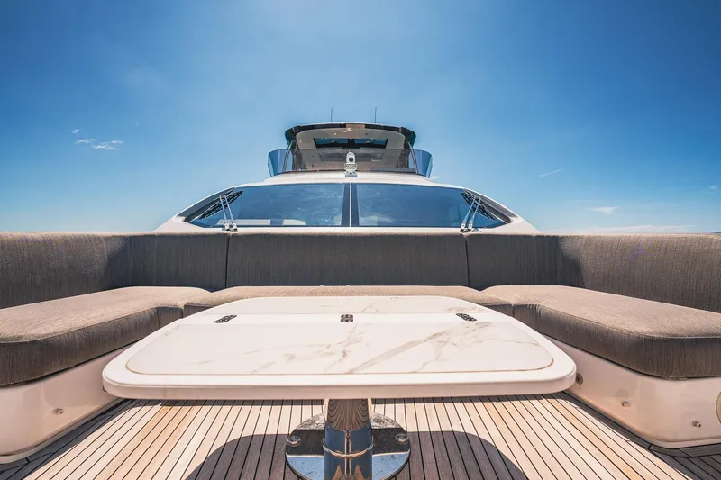 Transcendence Yacht Photos Pics Azimut 78 Flybridge 2020 yacht with elegant seating and table under clear blue sky.