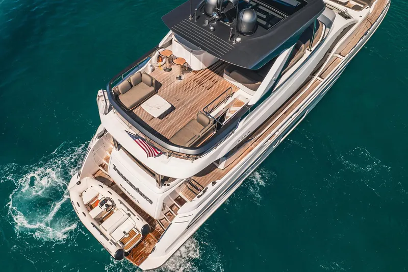 Transcendence Yacht Photos Pics Aerial view of 2020 Azimut 78 Flybridge yacht cruising in clear blue waters.