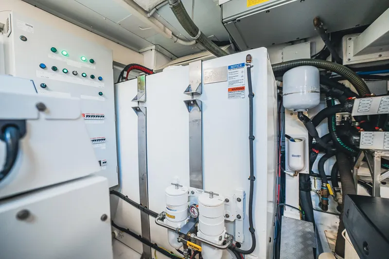 Transcendence Yacht Photos Pics Engine room of 2020 Azimut 78 Flybridge yacht with control panels and machinery.