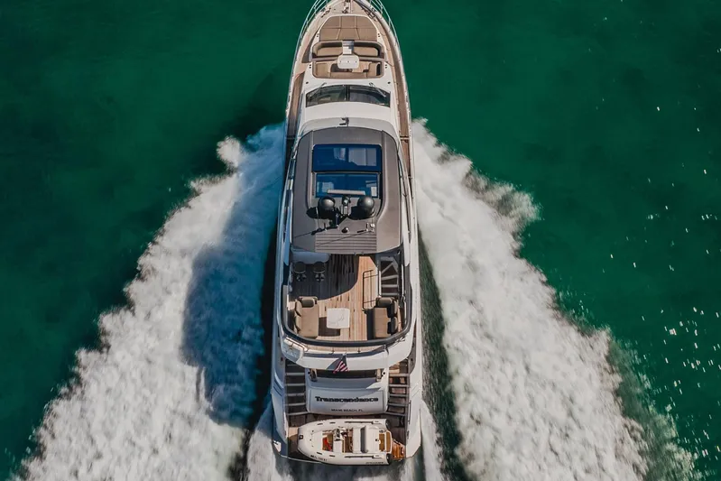 Transcendence Yacht Photos Pics Aerial view of 2020 Azimut 78 Flybridge yacht cruising on turquoise water.