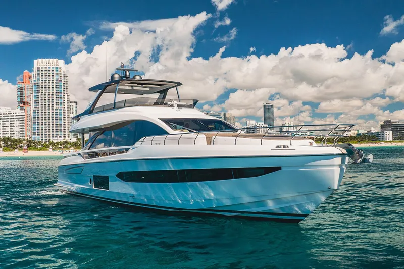 Transcendence Yacht Photos Pics Luxury 2020 Azimut 78 Flybridge yacht cruising near city skyline under blue skies.