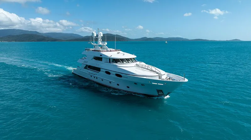  Yacht Photos Pics Luxurious 2003 Sovereign Tri-Deck yacht cruising on clear blue ocean waters.