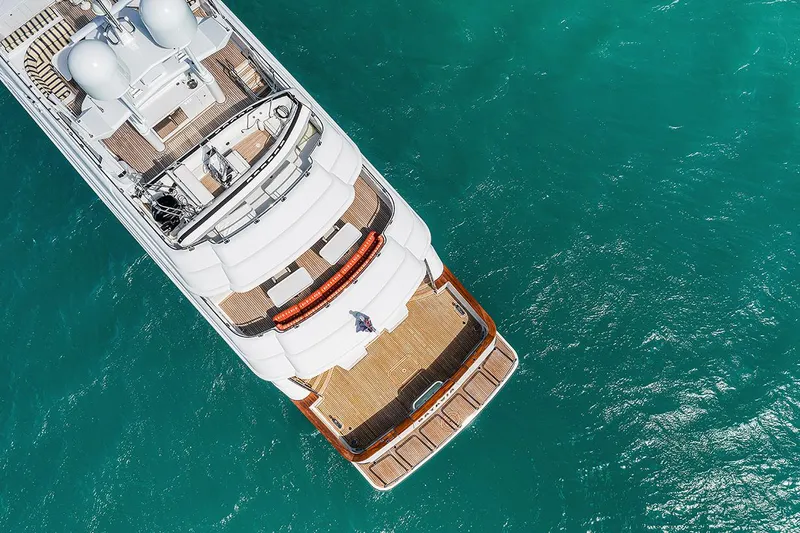  Yacht Photos Pics Aerial view of 2003 Sovereign Tri-Deck yacht on turquoise water.