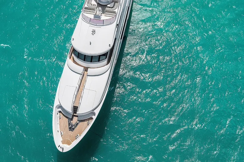  Yacht Photos Pics Aerial view of 2003 Sovereign Tri-Deck yacht on turquoise water.