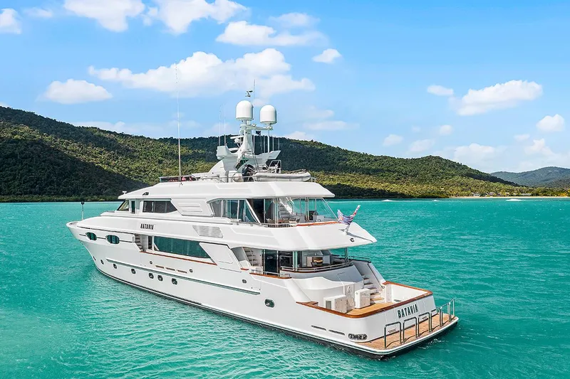  Yacht Photos Pics Luxury 2003 Sovereign Tri-Deck yacht on turquoise waters with scenic island backdrop.