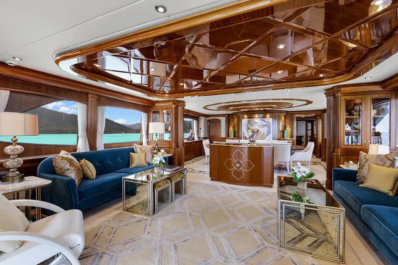  Yacht Photos Pics Luxurious interior of 2003 Sovereign Tri-Deck yacht with elegant wood finishes and plush seating.