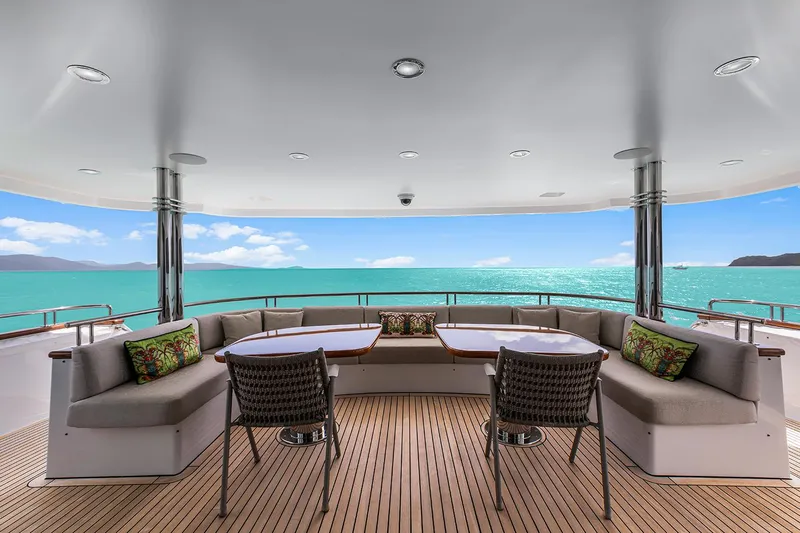  Yacht Photos Pics Luxurious Sovereign Tri-Deck yacht deck with ocean view, featuring elegant seating, 2003 model.