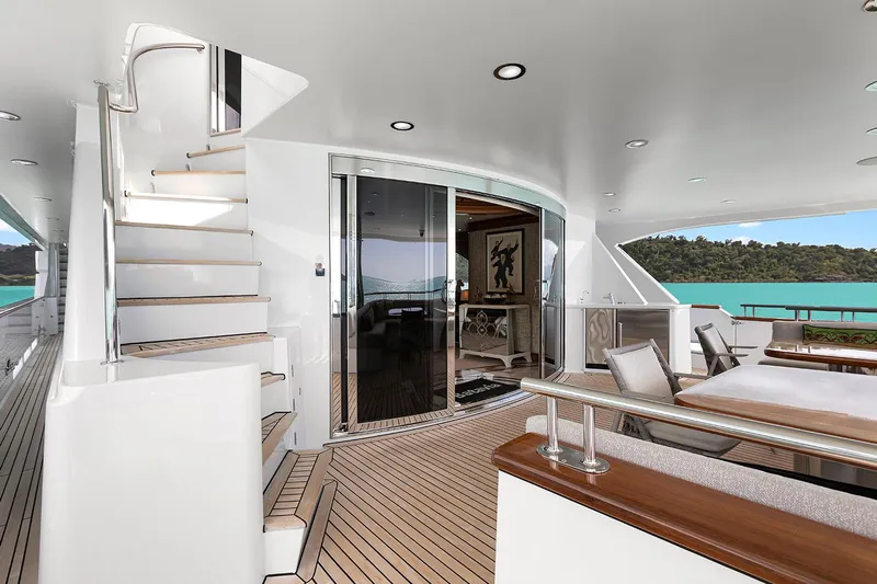  Yacht Photos Pics Luxurious 2003 Sovereign Tri-Deck yacht with elegant outdoor seating and scenic ocean view.