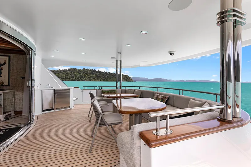  Yacht Photos Pics Luxurious 2003 Sovereign Tri-Deck yacht deck with elegant seating and stunning ocean views.