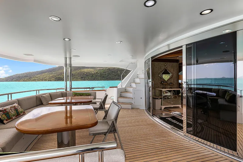  Yacht Photos Pics Luxurious Sovereign Tri-Deck yacht deck with seating, ocean view, and elegant design, 2003 model.