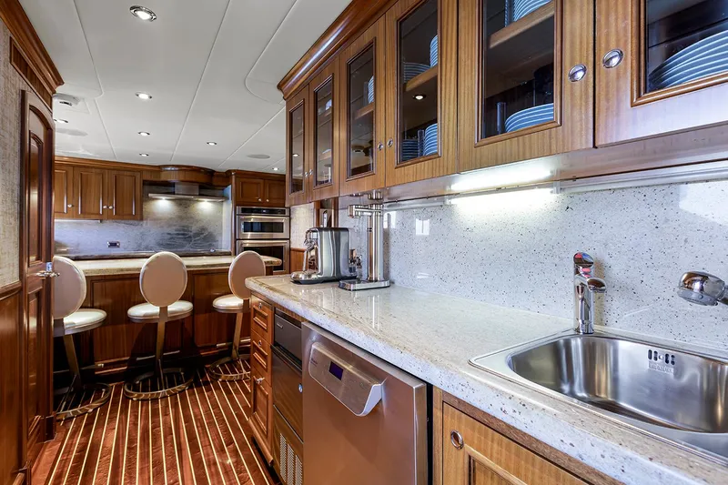  Yacht Photos Pics Luxurious kitchen interior on 2003 Sovereign Tri-Deck yacht with wooden cabinetry and modern appliances.