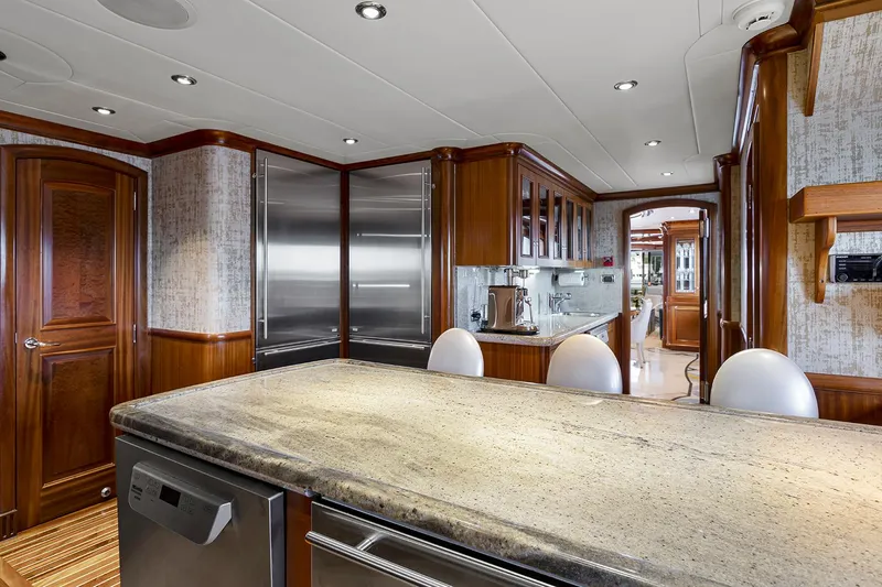  Yacht Photos Pics Luxurious kitchen interior on 2003 Sovereign Tri-Deck yacht with modern appliances and wood finishes.