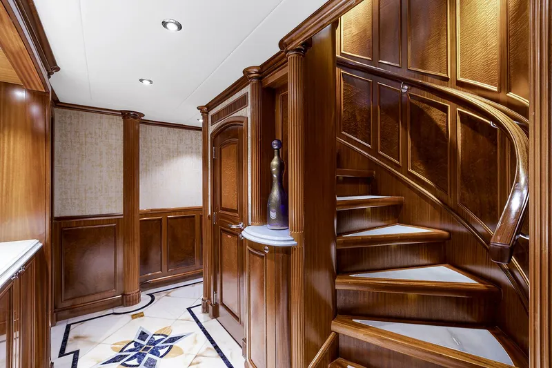  Yacht Photos Pics Luxurious wooden staircase on 2003 Sovereign Tri-Deck yacht interior.