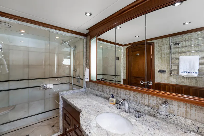  Yacht Photos Pics Luxurious bathroom in 2003 Sovereign Tri-Deck yacht with granite countertop and glass shower.