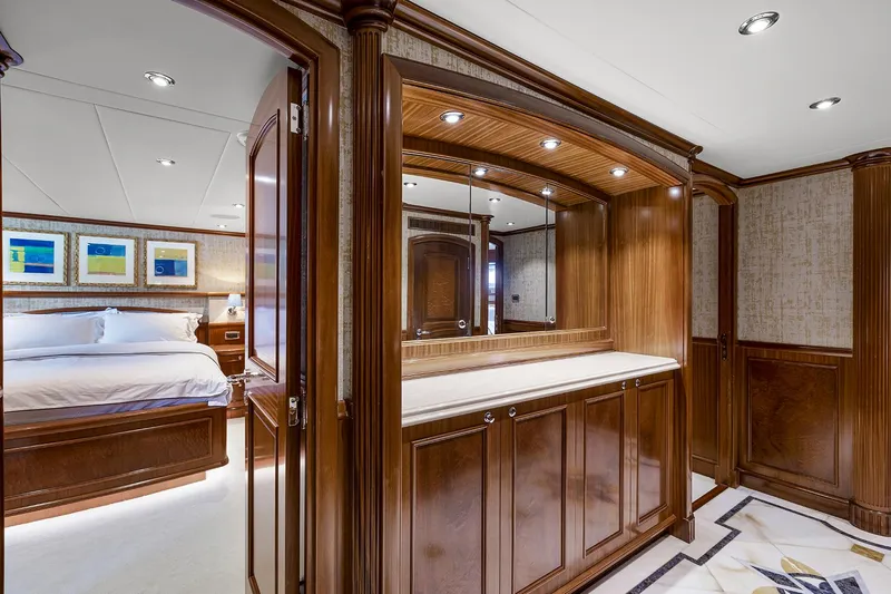  Yacht Photos Pics Luxurious Sovereign Tri-Deck 2003 yacht interior with elegant wood paneling and spacious bedroom.