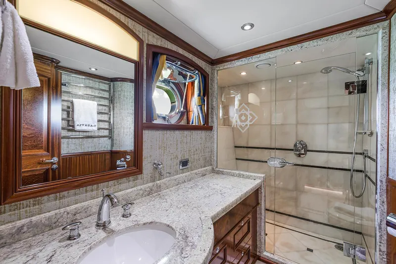  Yacht Photos Pics Luxurious bathroom in 2003 Sovereign Tri-Deck yacht with marble countertop and glass shower.