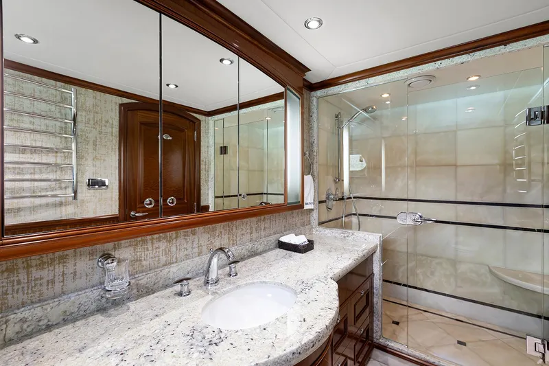  Yacht Photos Pics Luxurious bathroom on 2003 Sovereign Tri-Deck yacht with granite countertop and glass shower.