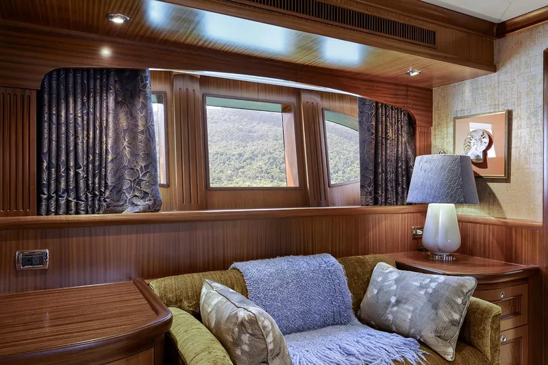  Yacht Photos Pics Luxurious interior of 2003 Sovereign Tri-Deck yacht with elegant wood paneling and plush seating.