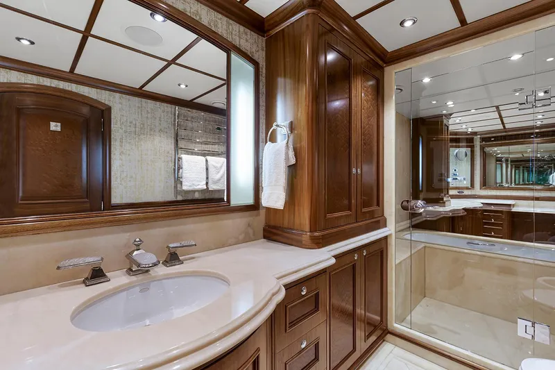  Yacht Photos Pics Luxurious Sovereign Tri-Deck 2003 yacht bathroom with elegant wood cabinetry and modern fixtures.