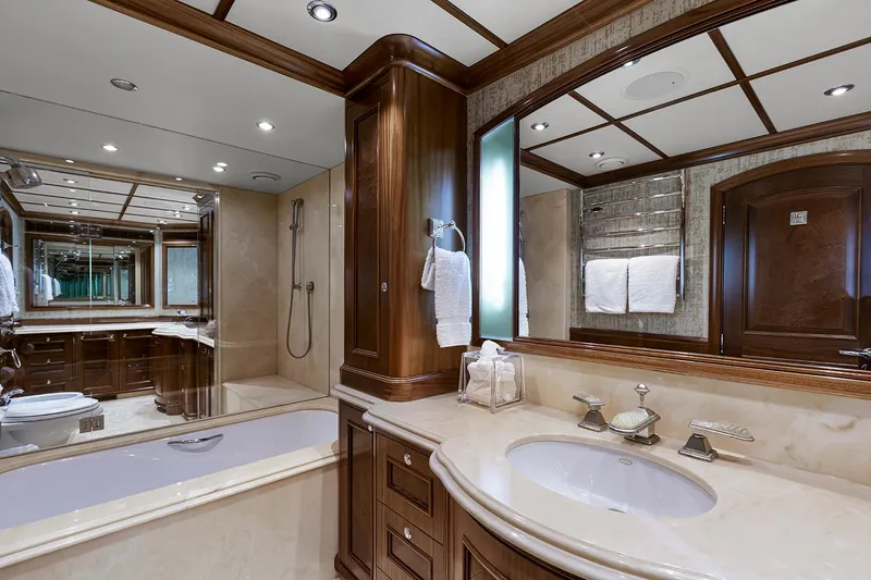  Yacht Photos Pics Luxurious bathroom in 2003 Sovereign Tri-Deck yacht with elegant wood and marble finishes.