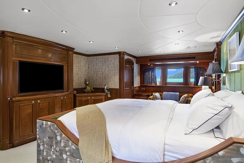  Yacht Photos Pics Luxurious bedroom in 2003 Sovereign Tri-Deck yacht with elegant wood paneling and large bed.