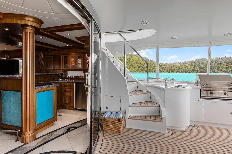  Yacht Photos Pics Luxurious 2003 Sovereign Tri-Deck yacht interior with kitchen, stairs, and outdoor grill.