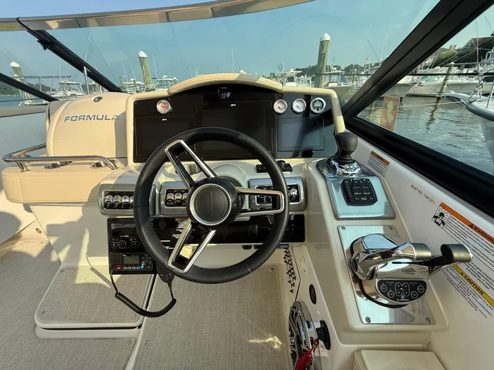 Yacht Photos Pics 2024 Formula 350 Crossover Bowrider helm with modern controls and steering wheel.