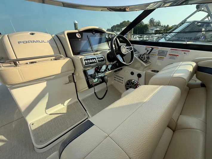  Yacht Photos Pics 2024 Formula 350 Crossover Bowrider interior with steering wheel and dashboard controls.