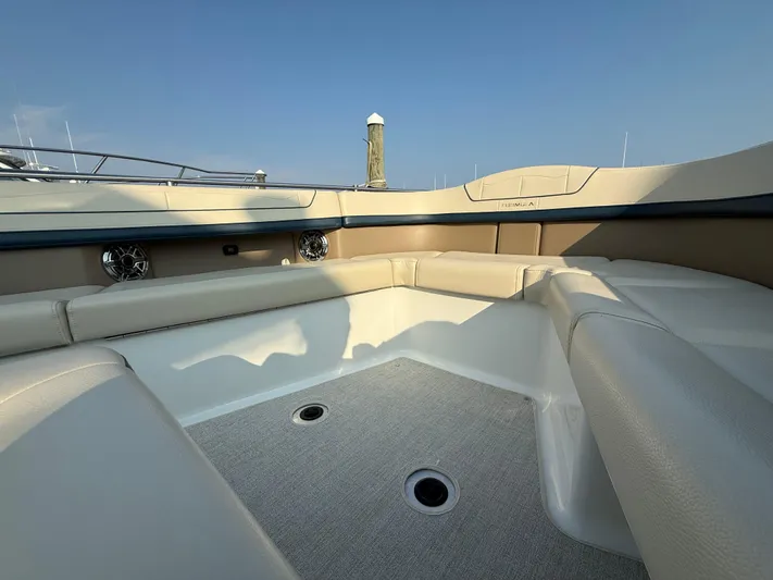  Yacht Photos Pics 2024 Formula 350 Crossover Bowrider interior with beige seating and speakers.